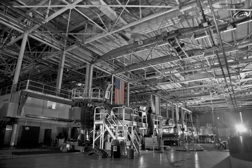 American flag hanging from the rafters inside a warehouse building